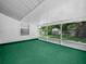 Bright sunroom with green carpet and a view of the backyard at 115 W Lee St, Plant City, FL 33563