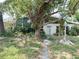 Charming single-story home featuring a mature tree-lined front yard and a covered front porch entry at 2415 Goldenrod St, Sarasota, FL 34239