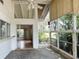 Bright sunroom featuring a stone floor, a ceiling fan, and multiple windows overlooking the lush outdoor greenery at 2415 Goldenrod St, Sarasota, FL 34239