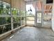 Bright sunroom featuring large windows, stone floors, and ample natural light at 2415 Goldenrod St, Sarasota, FL 34239