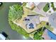 Aerial view of home on the water with solar panels, lush landscaping, and a spacious driveway at 4116 4Th Ne Ave, Bradenton, FL 34208