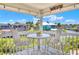 Covered porch with stylish seating offering a serene view of the water and surrounding community at 4116 4Th Ne Ave, Bradenton, FL 34208