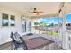 Inviting covered porch with seating, a ceiling fan, and a peaceful view of the neighborhood and palm trees at 4116 4Th Ne Ave, Bradenton, FL 34208