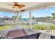 Relaxing porch with waterfront views, outdoor seating, and a ceiling fan, perfect for enjoying the outdoors at 4116 4Th Ne Ave, Bradenton, FL 34208