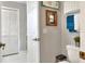 Neutral bathroom with a white toilet, gray walls, and decorative wall art at 4116 4Th Ne Ave, Bradenton, FL 34208