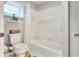 Clean bathroom with toilet, tub, and shower featuring white subway tile at 4116 4Th Ne Ave, Bradenton, FL 34208