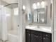 Bathroom featuring white vanity, dark cabinets, and a shower with a tub at 4116 4Th Ne Ave, Bradenton, FL 34208