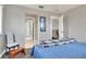 Bright bedroom featuring a comfortable bed, simple decor, and access to the hallway, creating a peaceful atmosphere at 4116 4Th Ne Ave, Bradenton, FL 34208