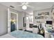 Bedroom with a queen bed, desk, decor shelves, and an ensuite bathroom at 4116 4Th Ne Ave, Bradenton, FL 34208