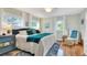 Bright bedroom featuring hardwood floors, a sitting area, and a ceiling fan at 4116 4Th Ne Ave, Bradenton, FL 34208