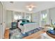 Bright bedroom featuring hardwood floors, a ceiling fan, and a cozy armchair at 4116 4Th Ne Ave, Bradenton, FL 34208