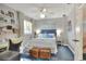 Cozy bedroom with a queen bed, blue accents, desk, and decor shelves at 4116 4Th Ne Ave, Bradenton, FL 34208