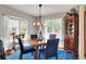 Elegant dining room with bay window, chandelier, and wooden table set at 4116 4Th Ne Ave, Bradenton, FL 34208