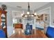 Traditional dining room with a decorative chandelier and views into the kitchen and entry at 4116 4Th Ne Ave, Bradenton, FL 34208