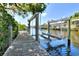 Waterfront view from wooden dock and boat lift with views of neighboring homes at 4116 4Th Ne Ave, Bradenton, FL 34208