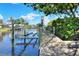 Wooden dock with boat lift leading out to the waterfront and neighborhood views at 4116 4Th Ne Ave, Bradenton, FL 34208