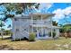 Backyard view of the two-story home featuring white siding and an outdoor patio at 4116 4Th Ne Ave, Bradenton, FL 34208