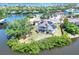 Waterfront home featuring a back deck and a screened porch surrounded by lush greenery at 4116 4Th Ne Ave, Bradenton, FL 34208