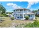 Two-story home featuring white siding, a balcony, a patio, and a backyard at 4116 4Th Ne Ave, Bradenton, FL 34208