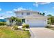 Two-story home featuring a lush landscaped yard, two car garage, and a beautiful green front door at 4116 4Th Ne Ave, Bradenton, FL 34208