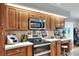The kitchen features stainless steel appliances, wood cabinetry, and tile countertops at 4116 4Th Ne Ave, Bradenton, FL 34208