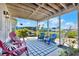 Spacious outdoor patio with blue lounge chairs, a swing, and lush landscaping at 4116 4Th Ne Ave, Bradenton, FL 34208