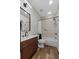 The bathroom has a modern vanity and a shower-tub combo with elegant finishes at 6007 Hammock Hill Ave, Lithia, FL 33547
