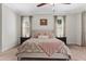 Comfortable bedroom with a ceiling fan, plush carpet and two nightstands at 6007 Hammock Hill Ave, Lithia, FL 33547