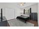 Well-lit bedroom with a large window and a full-sized bed with black comforter at 6007 Hammock Hill Ave, Lithia, FL 33547