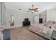 Bright bedroom with a ceiling fan, access to the patio, and a walk-in closet at 6007 Hammock Hill Ave, Lithia, FL 33547