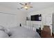 This bedroom features a ceiling fan, tv, closet, and access to the bathroom at 6007 Hammock Hill Ave, Lithia, FL 33547
