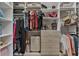 Bright walk-in closet with custom shelving, drawers, and hanging rods for optimal organization at 6007 Hammock Hill Ave, Lithia, FL 33547