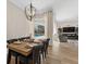 Elegant dining area features a wooden table set for a meal, with a view of the sparkling backyard pool at 6007 Hammock Hill Ave, Lithia, FL 33547