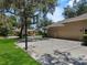 A three car garage next to a concrete driveway with basketball hoop at 6007 Hammock Hill Ave, Lithia, FL 33547