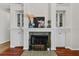 Close-up of a fireplace with dark tile surround flanked by built-in cabinets with glass displays and cabinet doors at 6007 Hammock Hill Ave, Lithia, FL 33547