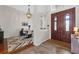 Elegant foyer with hardwood flooring, chandelier, and stylish decor, leading to the dining room at 6007 Hammock Hill Ave, Lithia, FL 33547