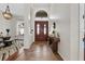 Welcoming foyer with wood floors, chandelier, and a view into the dining room at 6007 Hammock Hill Ave, Lithia, FL 33547