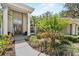 Inviting front entrance with a double door, columns, and lush landscaping at 6007 Hammock Hill Ave, Lithia, FL 33547