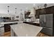 Spacious kitchen with a large center island, pendant lights, tile backsplash, and stainless steel appliances at 6007 Hammock Hill Ave, Lithia, FL 33547