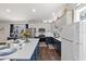 Bright kitchen featuring two-tone cabinets, stainless appliances, and a large island with quartz countertops at 6007 Hammock Hill Ave, Lithia, FL 33547