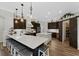Open concept kitchen with large island, bar seating, pendant lighting, stainless steel appliances, and barn door pantry at 6007 Hammock Hill Ave, Lithia, FL 33547