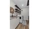 Functional laundry room with floating shelves, sink, and modern washer and dryer at 6007 Hammock Hill Ave, Lithia, FL 33547