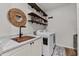Well-organized laundry room featuring wood-look tile floor, shelves and a modern sink at 6007 Hammock Hill Ave, Lithia, FL 33547