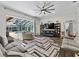 Cozy living room with a view of the screened in pool, comfortable seating, and entertainment center at 6007 Hammock Hill Ave, Lithia, FL 33547