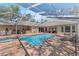 Enclosed pool and spa area with brick patio, lounge chair, and outdoor dining set at 6007 Hammock Hill Ave, Lithia, FL 33547