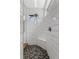 White tiled shower with built-in seating and multi-patterned tile flooring at 6007 Hammock Hill Ave, Lithia, FL 33547