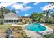 Large kidney-shaped pool in backyard with pool deck and grass area, house in the background at 114 Windy Pl, Brandon, FL 33511