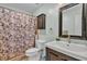 Bathroom with a vanity, a mirror, and a shower with a patterned curtain at 114 Windy Pl, Brandon, FL 33511