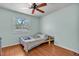 Bedroom with wood floors, a window, and a ceiling fan at 114 Windy Pl, Brandon, FL 33511