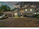 Charming two-story home featuring a well-manicured lawn and attached garage, exuding curb appeal at 114 Windy Pl, Brandon, FL 33511